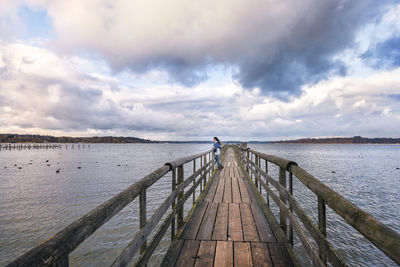 Pier over sea against sky