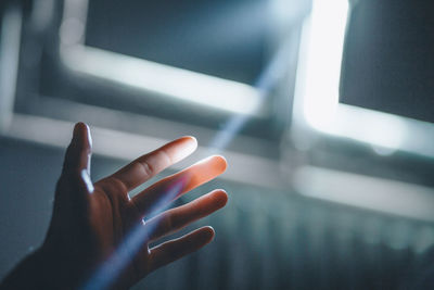 Sunlight streaming on hand of person