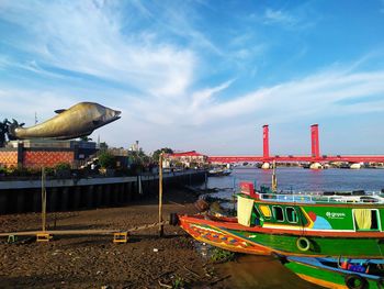 Boats moored on beach against sky