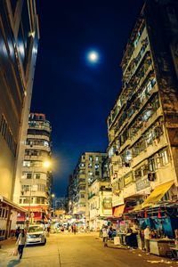 View of city street and buildings at night