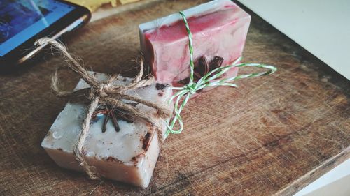 High angle view of soap and star anise tied with string on table
