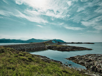 Scenic view of bridge and sea against sky