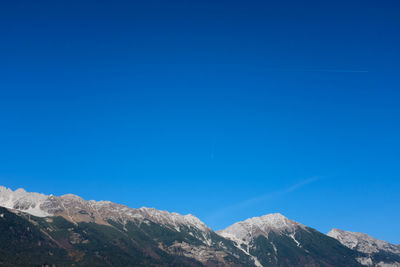 Low angle view of mountain against clear blue sky