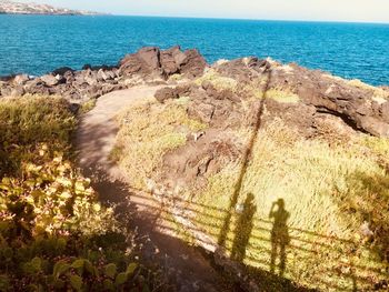 Scenic view of rocks on beach against sky