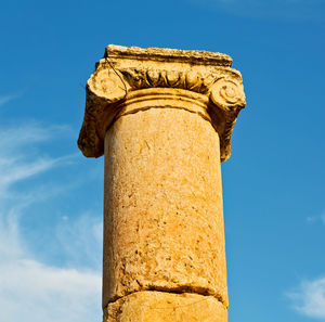 Low angle view of old ruin building against blue sky