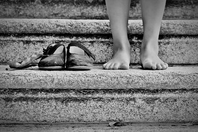 Low section of woman standing on staircase