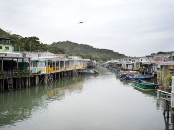 Boats in canal against sky