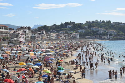 High angle view of people at beach against sky