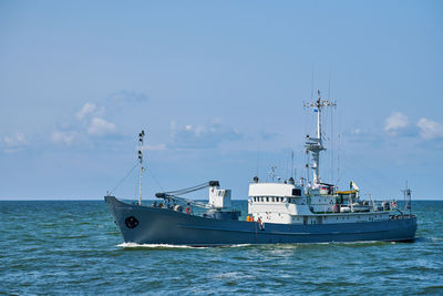 Survey vessel, research vessel patrol boat sailing in bright blue baltic sea, navy patrol vessel