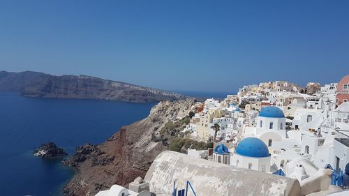 Panoramic view of buildings against blue sky