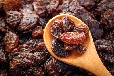 Close-up of wooden spoon on raisins