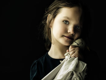 Portrait of girl against black background