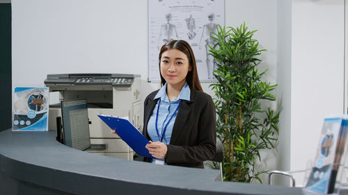 Portrait of young businesswoman working at office