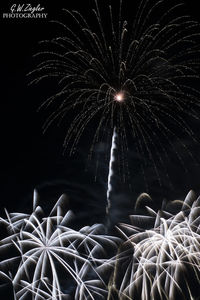 Low angle view of firework display at night