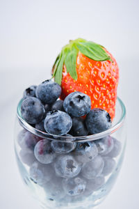 Close-up of strawberries in bowl against white background