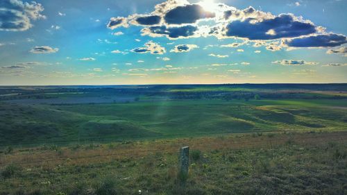 Scenic view of landscape against cloudy sky