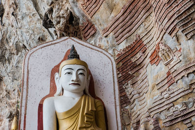 Statue of buddha against building