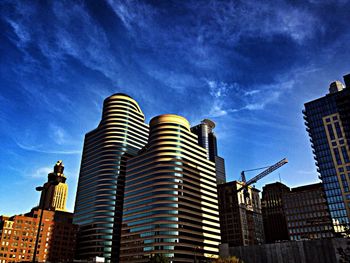 Low angle view of buildings against cloudy sky
