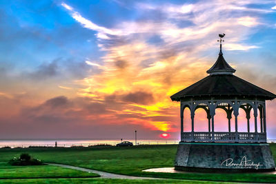 View of building against cloudy sky during sunset