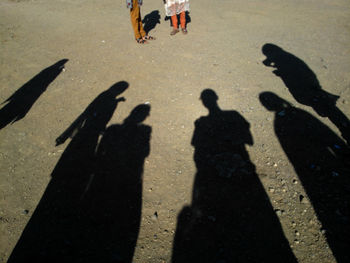 Shadow of people standing at beach