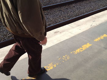 Woman standing on railroad track