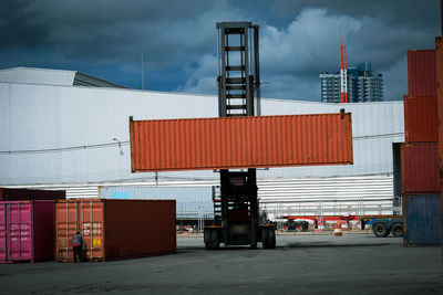 View of commercial dock against cloudy sky