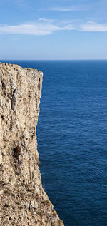 Scenic view of rock formation in sea against sky