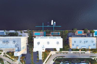 High angle view of buildings by sea against sky