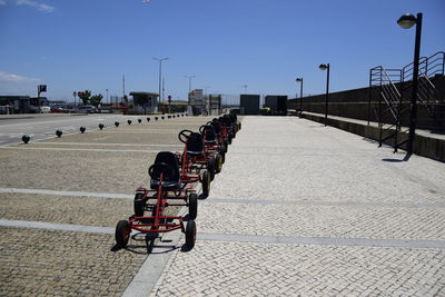 People riding bicycle on road against clear sky