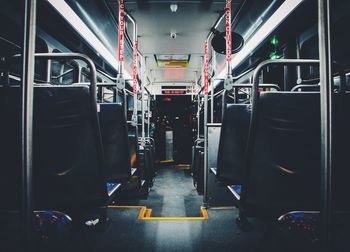 Interior of illuminated empty bus at night