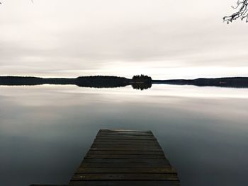 Pier on lake against sky