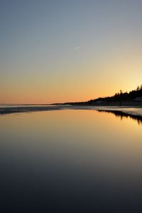 Scenic view of sea against clear sky during sunset