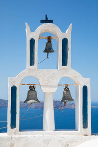 Bell tower against clear blue sky