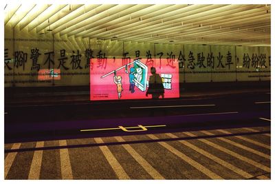 Text on illuminated railroad station platform