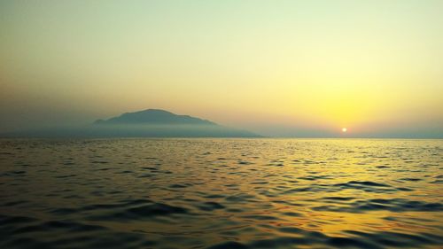 Scenic view of sea against clear sky during sunset