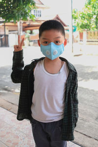 Portrait of boy standing outdoors