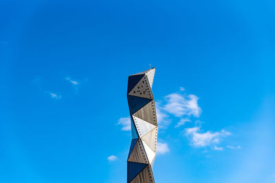 Low angle view of road sign against blue sky