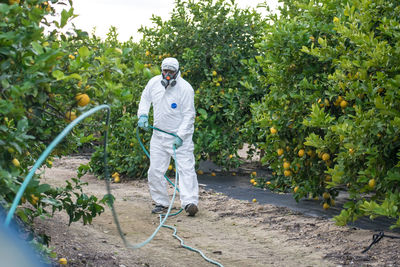 Full length of man standing by plants