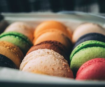 Close-up of multi colored macaroons in box