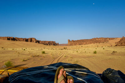 Low section of man relaxing on land