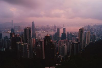Illuminated cityscape against sky at night