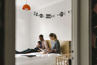 Parents with baby on bed