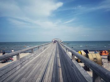 Pier over sea against sky