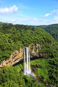 Scenic view of waterfall against sky