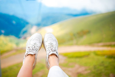 Low section of woman standing on mountain