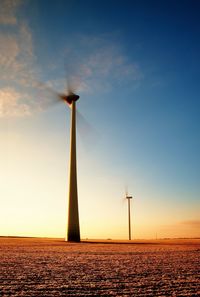 Wind turbines farm at sunset in morning meadow