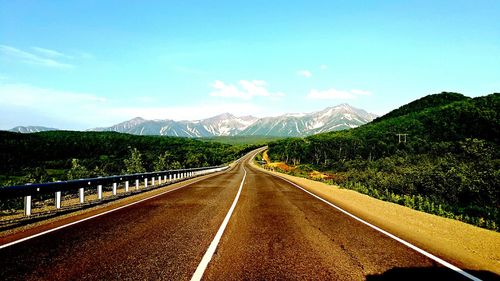 Country road leading towards mountains