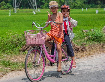 Portrait of a smiling young woman riding bicycle