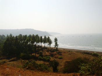 Scenic view of mountains and sea against clear sky