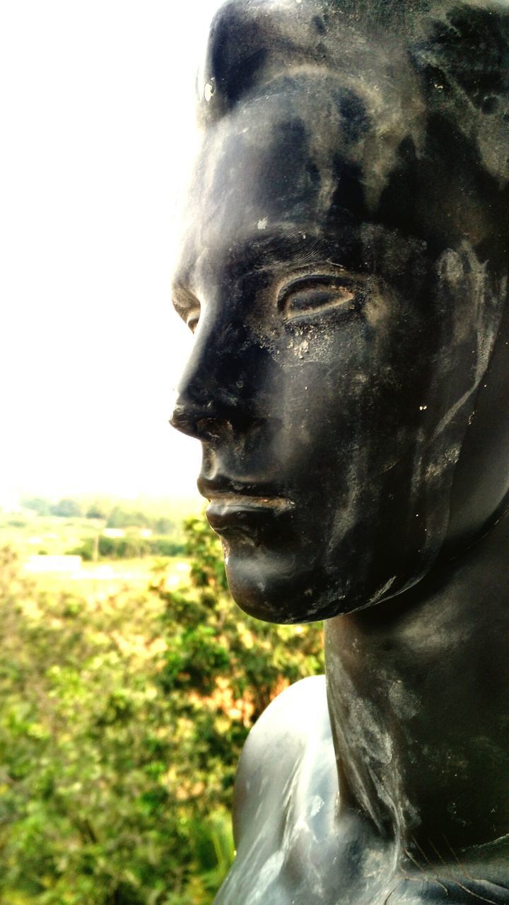 CLOSE-UP OF STATUE AGAINST SKY